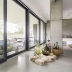 Salon moderne avec fenêtres et décorations élégantes.